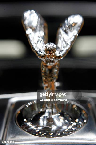 The angel hood ornament of a Rolls-Royce automobile sits on a Phantom Drophead Coupe luxury car on the first day of the media preview for the Geneva...