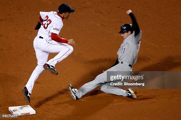 Julio Lugo of the Boston Red Sox, left, jumps out of the way of Brad Hawpe of the Colorado Rockies while turning a double play in Game 2 of the Major...