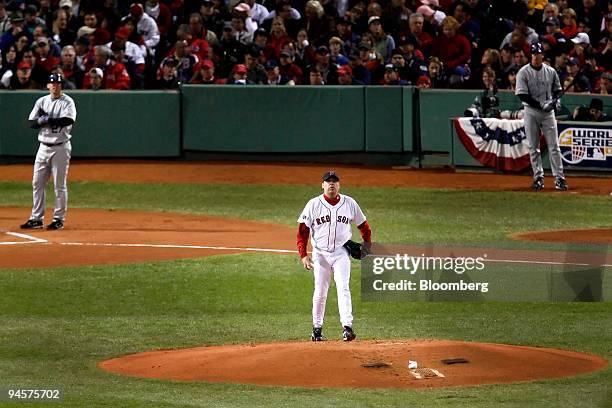 Curt Schilling of the Boston Red Sox walks back on the mound after surrendering a first-inning run against the Colorado Rockies in Game 2 of the...