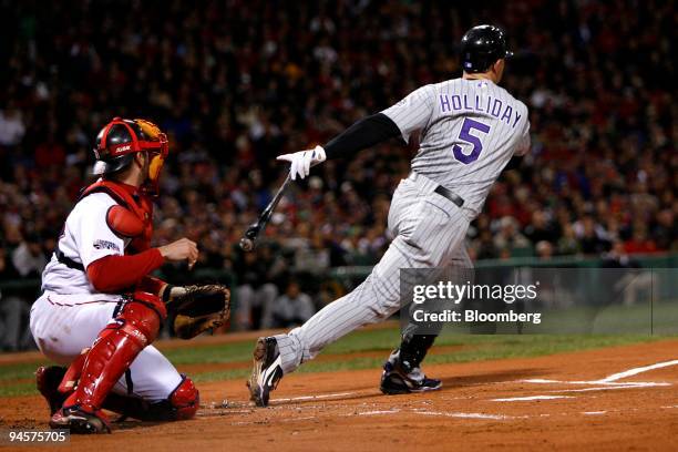 Matt Holliday of the Colorado Rockies singles to left against Curt Schilling of the Boston Red Sox during Game 2 of the Major League Baseball World...