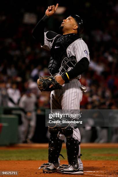 Yorvit Torrealba of the Colorado Rockies points skyward before catching for teammate Ubaldo Jimenez against the Boston Red Sox during Game 2 of the...
