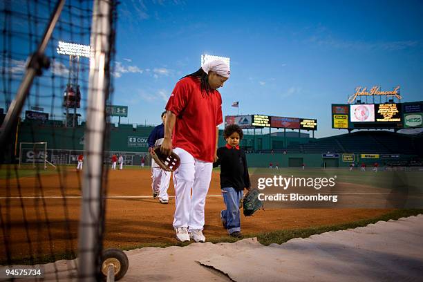 Manny Ramirez of the Boston Red Sox walks off the field with his son, Manny Ramirez Jr., prior to Game 2 of the Major League Baseball World Series...