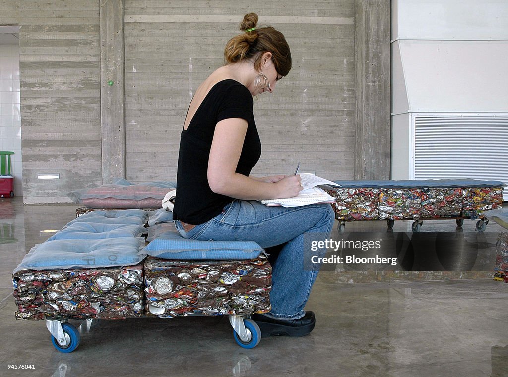 A woman sits on a bench made from recycled cans at the Hiriy