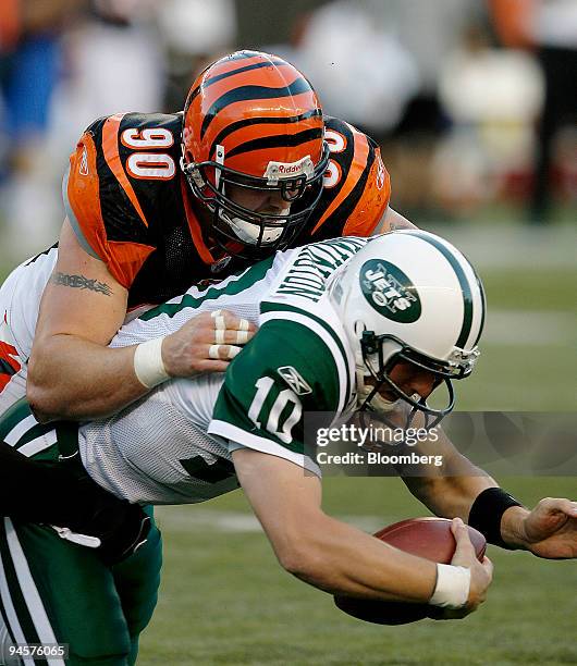 Chad Pennington, No. 10, quarterback for the New York Jets, is sacked by Justin Smith of the Cincinnati Bengals during the third quarter of their...