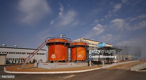 Two large tanks of sulfuric acid stand outside a processing facility at the East Mynkuduk uranium mine in Kyzemshek, Kazakhstan, on Thursday, Oct....