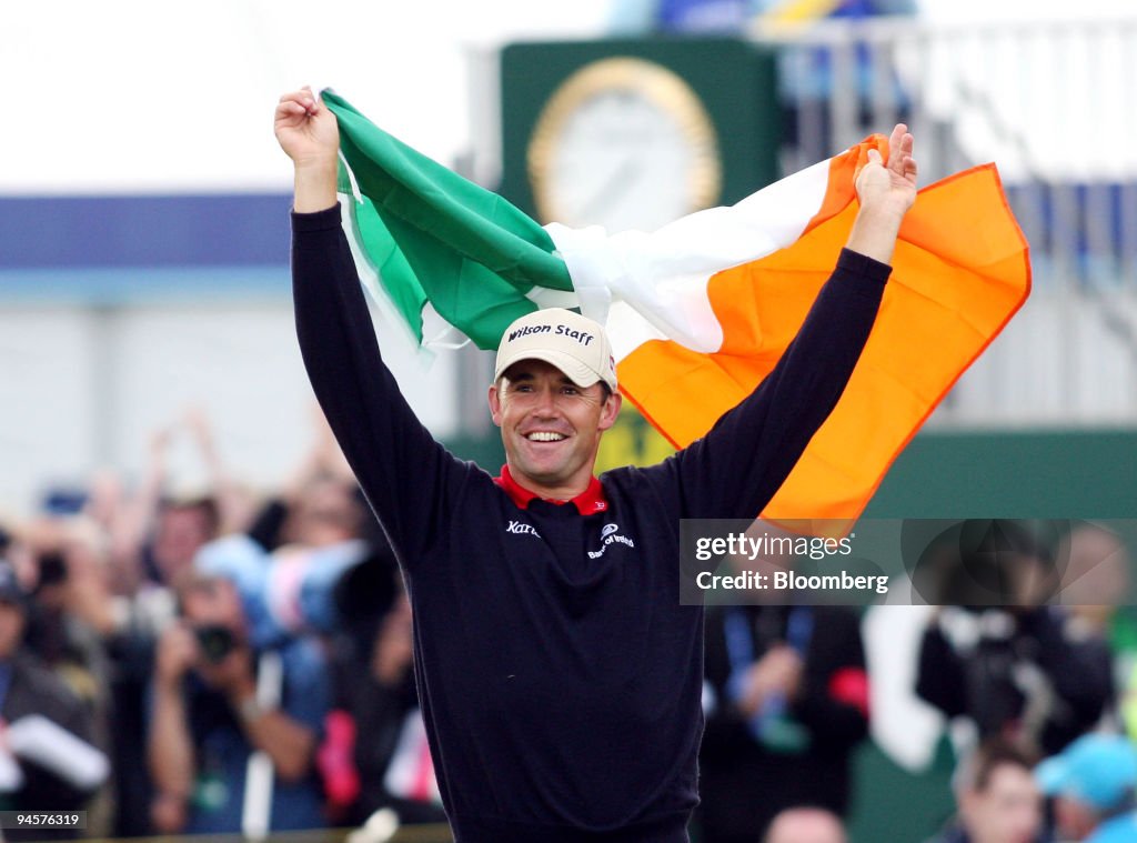 Padraig Harrington of Ireland holds the Irish tricolour alof