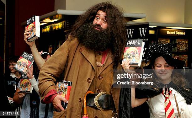 Saskia Haifierna, right, the first person to buy a copy of "Harry Potter and the Deathly Hallows" by J.K. Rowlings, poses with a fan dressed as the...