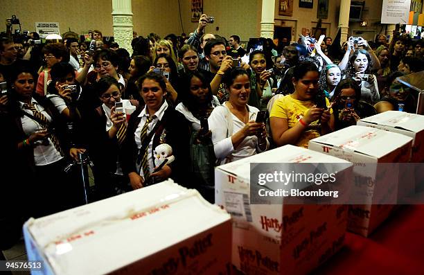 Harry Potter fans look at unopened boxes containing copies of "Harry Potter and the Deathly Hallows," the seventh and final title in the J.K. Rowling...