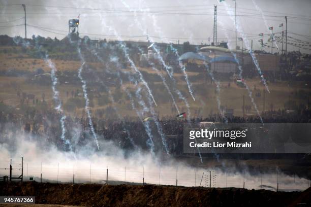 Israeli soldiers fire tear gas as Palestinian gathered for a protest on the Israel-Gaza border on April 13, 2018 in Nahal Oz, Israel. Thousands of...