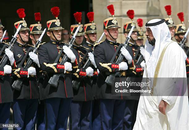 United Arab Emirates President Sheikh Khalifa bin Zayed al-Nahyan reviews the honor guard when meeting with French President Nicolas Sarkozy at the...