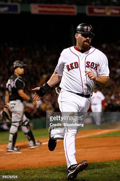 Kevin Youkilis of the Boston Red Sox runs towards the dugout after scoring against the Colorado Rockies during Game 1 of the Major League Baseball...