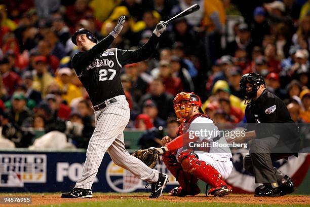 Garrett Atkins of the Colorado Rockies hits a double off of Josh Beckett of the Boston Red Sox during Game 1 of the Major League Baseball World...