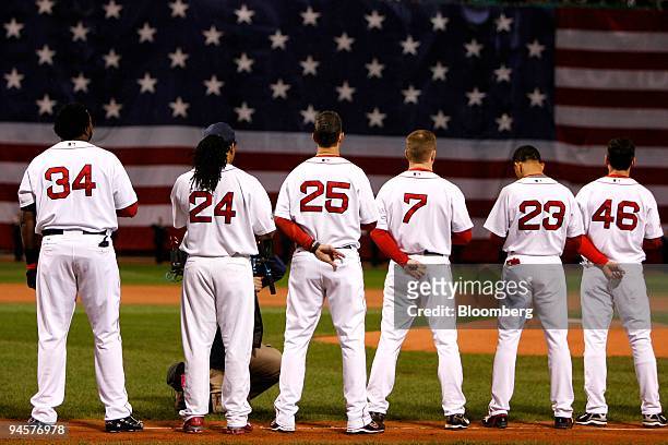 Members of the Boston Red Sox honor the U.S. Flag during the singing of the National Anthem before Game 1 of the Major League Baseball World Series...