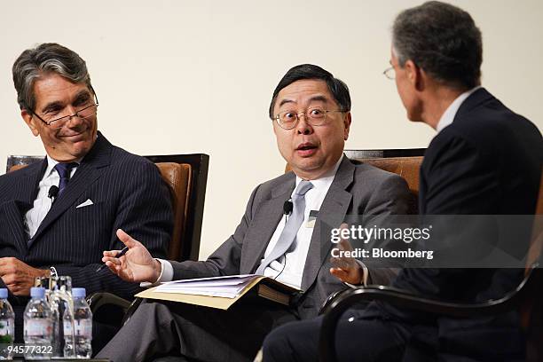Ronnie Chan, center, chairman of Hang Lung Properties Ltd., stresses a point while Philippe Collas, left, chief executive officer of global...