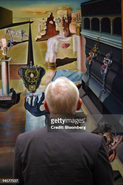 Visitor to the Dali and Film exhibition looks at Salvador Dali's painting ''The Invisible Man'' from 1930 at Tate Modern in London, U.K., Wednesday,...