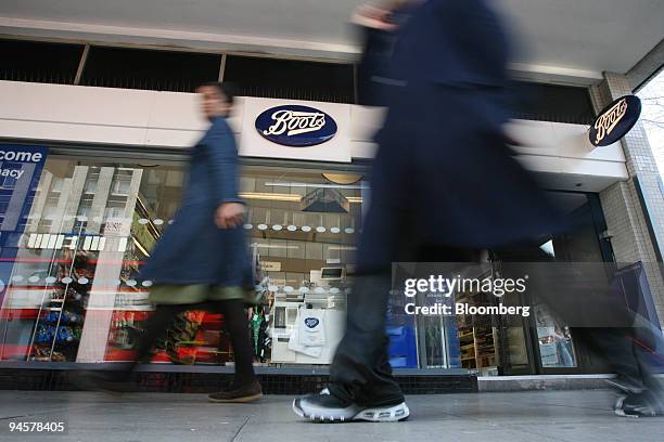 Pedestrians pass by a Boots pharmacy in London, U.K., Tuesday, March 27, 2007.