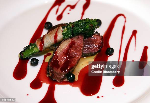 Medaillons de Foie Gras Poelees et Magret Canard en Duo Garni de Bouquet de Nanohana is arranged for a photo at the Restaurant Francais & library...