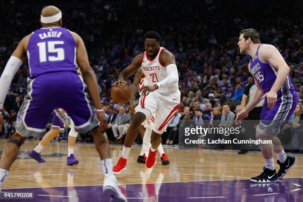 Chinanu Onuaku of the Houston Rockets drives to the basket against Vince Carter and Jack Cooley of the Sacramento Kings at Golden 1 Center on April...