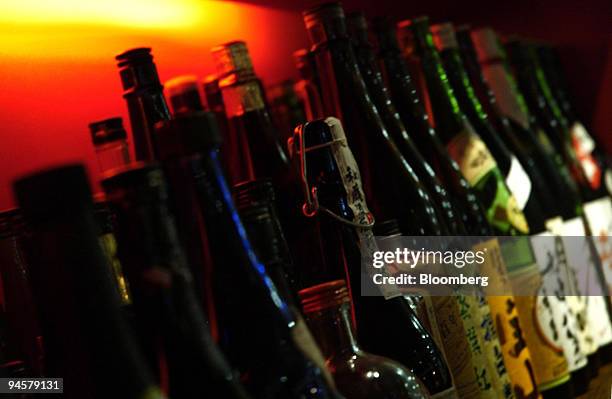 Bottles of Sake are displayed on the shelf of Takara restaurant at the Tokyo International Forum in Tokyo, Japan, on Monday, Oct. 22, 2007. Takara,...