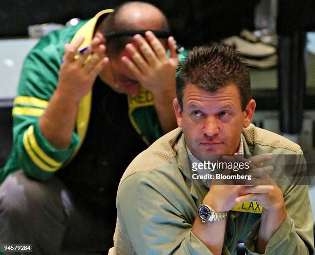 Traders work on the floor of the New York Mercantile Exchange in New York, U.S., on Monday, Oct. 22, 2007. Commodities fell the most in two weeks,...