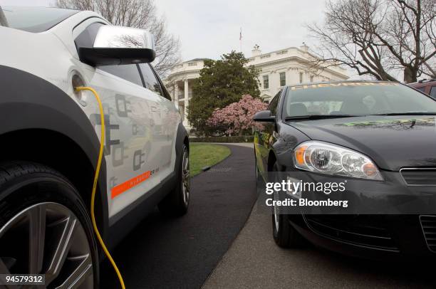 Ford HySeries Edge vehicle, left, sits plugged-in next to a Chevy E85 Impala on the driveway of the South Lawn of the White House as President Bush,...