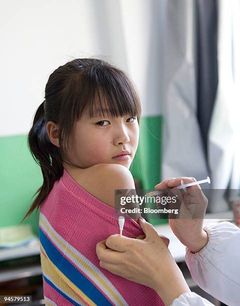 Young girl receives an injection of the Hepatitis B vaccine at a school in Ledu, Qinghai, China, on Monday, Sept. 17, 2007. Run by the Asian Liver...