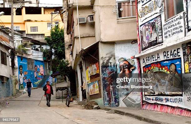 People walk down an alley that leads to the Complexo do Alemao 17 favelas, in Rio de Janeiro, Brazil, on May 24, 2007.