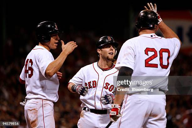 Dustin Pedroia of the Boston Red Sox, second from the left, celebrates with teammates after hitting a two-run home run against the Cleveland Indians...