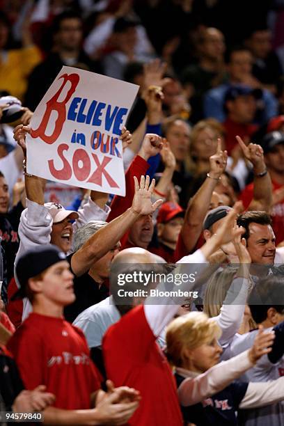 Fans support the Boston Red Sox during the seventh game against the Cleveland Indians in the American League Championship Series in Boston,...