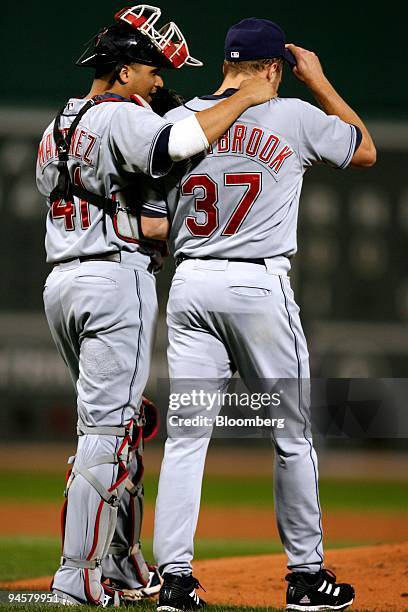 Victor Martinez, left, catcher for the Cleveland Indians, speaks with pitcher Jake Westbrook during the seventh game against the Boston Red Sox in...