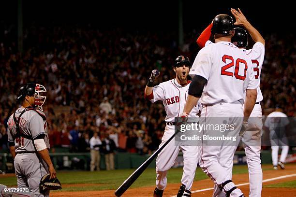 Dustin Pedroia of the Boston Red Sox, second from the left, celebrates with teammates after hitting a two-run home run against the Cleveland Indians...