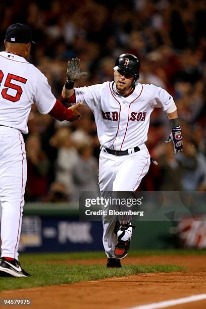 Dustin Pedroia of the Boston Red Sox, second from the left, rounds the bases after hitting a two-run home run against the Cleveland Indians in the...