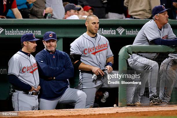 Eric Wedge, second from the left, manager of the Cleveland Indians, watches his team with coaches and Travis Hafner to his right from the dugout...