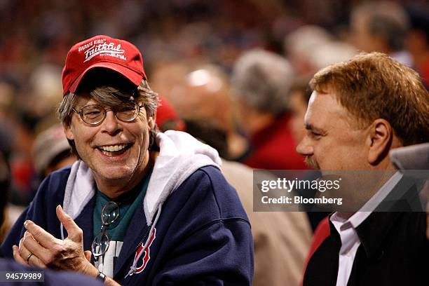 Author Stephen King, left, supports the Boston Red Sox during the seventh game against the Cleveland Indians in the American League Championship...