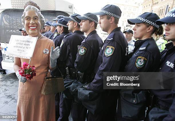 Protestor dressed as the Queen of England demonstrates near a police line in the central business district during day seven of the Asia-Pacific...