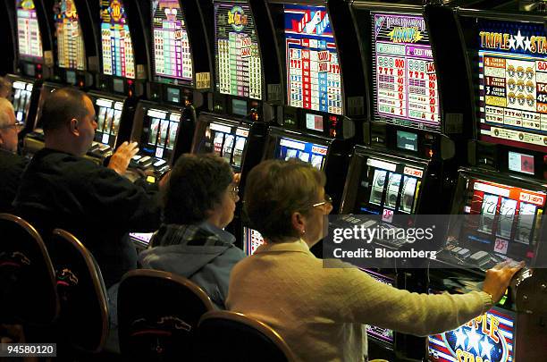 Patrons play the first slot machine gaming available in Pennsylvania at the Mohegan Sun at Pocono Downs Thursday, November 16, 2006 in Wilkes-Barre,...