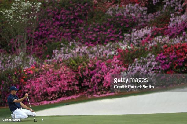 Jordan Spieth of the United States lines up a putt on the 13th hole during the first round of the 2018 Masters Tournament at Augusta National Golf...