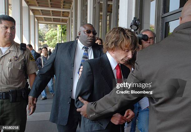 Music producer Phil Spector, center, with red tie, arrives at Los Angeles Superior Court, Tuesday, Sept. 18 in Los Angeles, California, U.S. The jury...