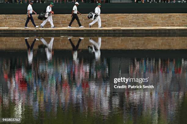 Marc Leishman of Australia and Tiger Woods of the United States cross the Sarazen Bridge on the 16th hole during the second round of the 2018 Masters...