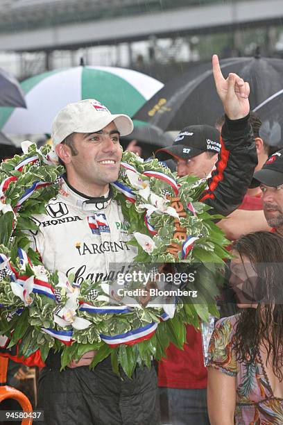 Dario Franchitti celebrates in the winners circle of the Indianapolis 500 after the race was called due to rain following in lap 166 of 200 at the...