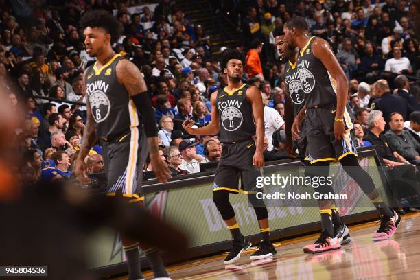 Quinn Cook of the Golden State Warriors, Kevin Durant of the Golden State Warriors and Jordan Bell of the Golden State Warriors exit the court during...