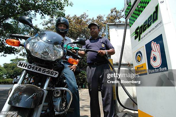 Motorcycle is filled with fuel at a Bharat Petroleum Corporation Ltd. Gas station in Mumbai, India, on Sunday, March 25, 2007. Petronet LNG Ltd.,...