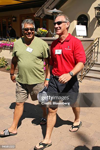 Greg Maffei, right, president and chief executive officer of Liberty Media Corp., talks with Henry "Hank" Vigil, vice president for consumer strategy...