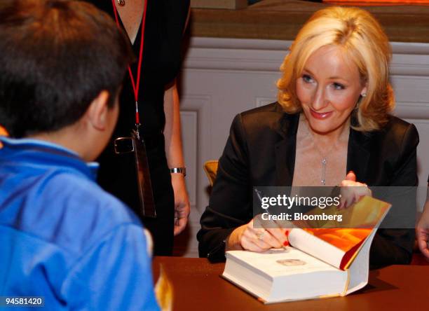 Author J.K. Rowling signs her book ?Harry Potter and the Deathly Hallows,? for schoolchildren during the Open Book Tour at Carnegie Hall in New York,...