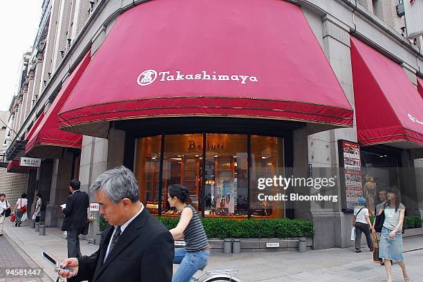 Pedestrians and shoppers walk past the Takashimaya department store's main branch in Tokyo, Japan, on Monday, July 9, 2007. Japanese retailer shares...