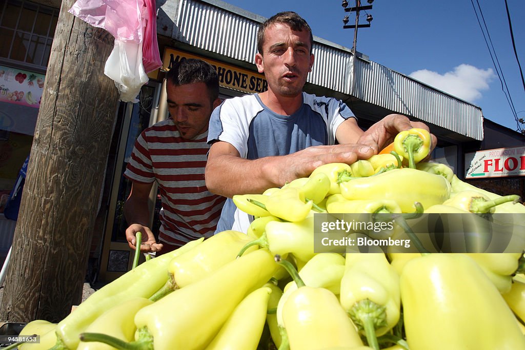 A vendor arranges peppers at a market in Pristina, Kosovo, S
