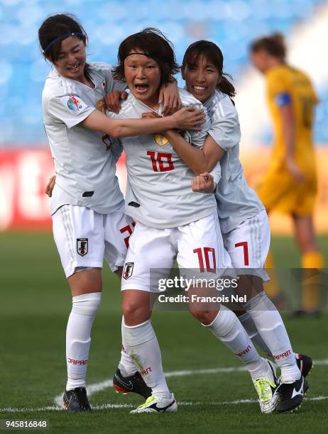 Mizuho Sakaguchi of Japan celebrates with Risa Shimizu and Emi Nakajima scoring the opening goal during the AFC Women's Asian Cup Group B match...