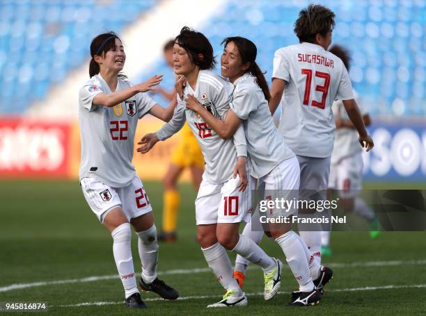 Mizuho Sakaguchi of Japan celebrates with Risa Shimizu and Emi Nakajima scoring the opening goal during the AFC Women's Asian Cup Group B match...