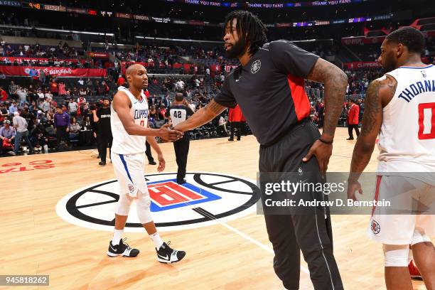 DeAndre Jordan of the LA Clippers and C.J. Williams of the LA Clippers high five during the game between the two teams on April 9, 2018 at STAPLES...