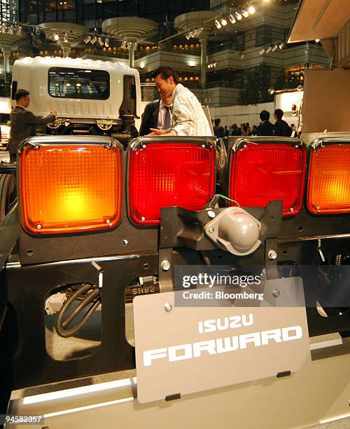 Journalists look at a Isuzu Motors Ltd. Forward mid-duty truck at a news conference in Tokyo, Japan, on Thursday, May 24, 2007. Isuzu Motors Ltd.,...